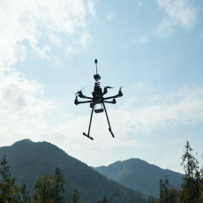 person using crane to move industrial gear box in engineering factory