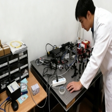 person using crane to move industrial gear box in engineering factory