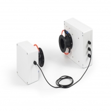 person using crane to move industrial gear box in engineering factory