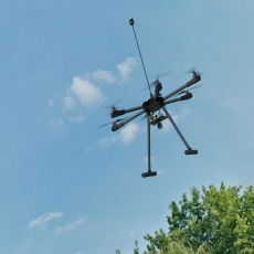 person using crane to move industrial gear box in engineering factory
