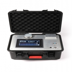 person using crane to move industrial gear box in engineering factory